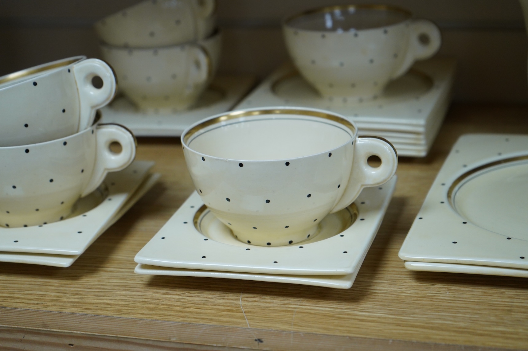 A Clarice Cliff Biarritz-shape 21-piece part teaset including trencher plates and saucers, impressed date-code 1935, jug 13cm